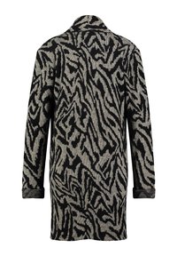 Cappotto lavorato a maglia con un pattern astratto a zebra nero e beige, maniche lunghe e colletto classico con polsini arrotolati.