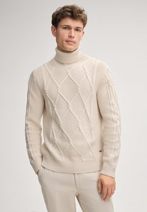 Sweter z golfem w kremowym kolorze z teksturowanym wzorem w diamenty i ribbami na mankietach. Wykonany z miękkiego materiału dzianinowego, o dopasowanym kroju.
