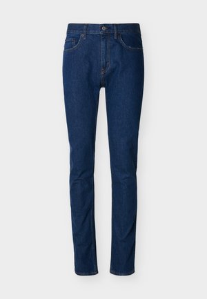 Σκούρο μπλε τζιν με στενή γραμμή, σχεδίαση με πέντε τσέπες, ορατή ραφή και κλείσιμο με κουμπί στη μέση. Λεία υφή.