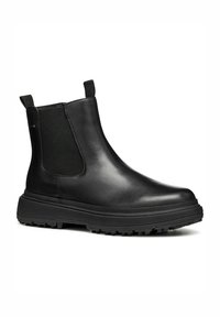 Botas Chelsea negras de cuero con paneles elásticos laterales, suela de goma texturizada, tiradores en la parte trasera y un acabado liso.