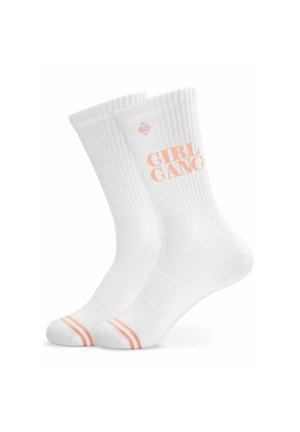Pair of white crew socks with ribbed cuffs, peach-colored "GIRL GANG" text, and two peach stripes on the toes.
