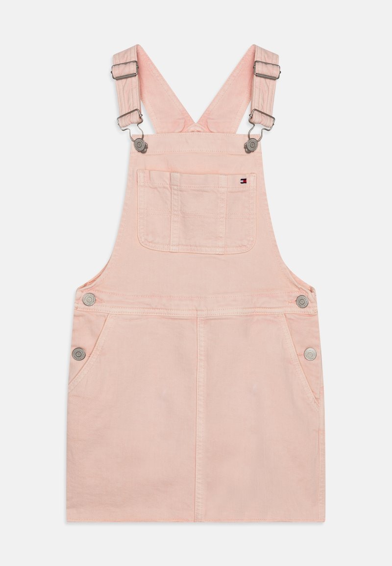 Robe salopette en denim rose avec bretelles réglables, deux poches avant et des accents de boutons en métal argenté. Texture lisse et design simple.