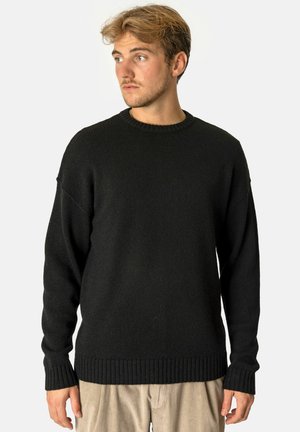 Black sweater made of ribbed knit fabric, featuring a round neckline and long sleeves, with a fitted ribbed hem and cuffs.