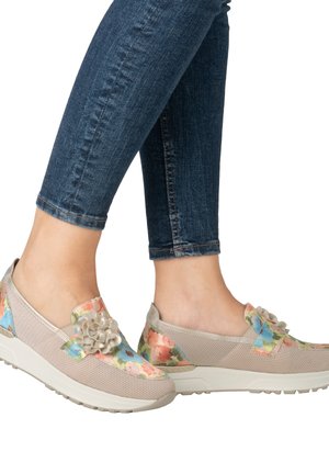 Floral slip-on shoes in beige mesh with a textured sole. Features a decorative flower accent and multicolored floral pattern on the upper.