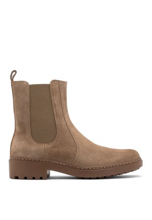Suede ankle boot in light tan with elastic side panels. Round toe and textured rubber sole with lug pattern. Pull tab for easy wear.
