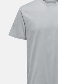 Light gray cotton T-shirt with a round neckline, short sleeves, and a smooth texture, featuring double-stitched seams for durability.