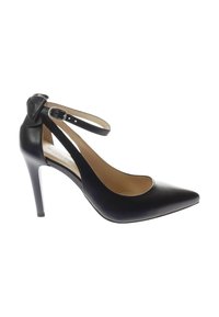 Black leather high-heeled pump with pointed toe, ankle strap, and bow detail. Smooth texture with a glossy finish and a stiletto heel.