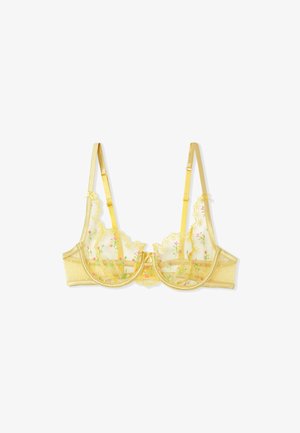 Yellow lace bra with floral embroidery, sheer mesh cups, and polka dot detailing. Adjustable straps and a smooth satin band.