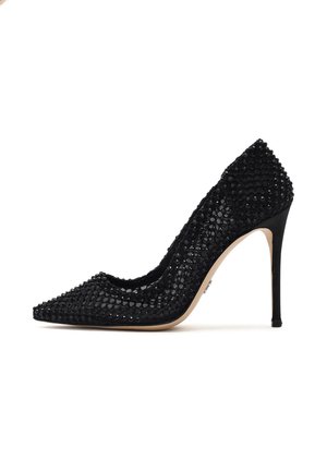 Décolleté nero con tacco a spillo, con punta affusolata, caratterizzata da una tomaia testurizzata decorata con paillettes nere e un sottile tacco a spillo.