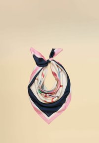Écharpe en soie avec des bordures roses, bleu marine et blanches nouée en un nœud, présentant des motifs abstraits multicolores sur un fond beige.