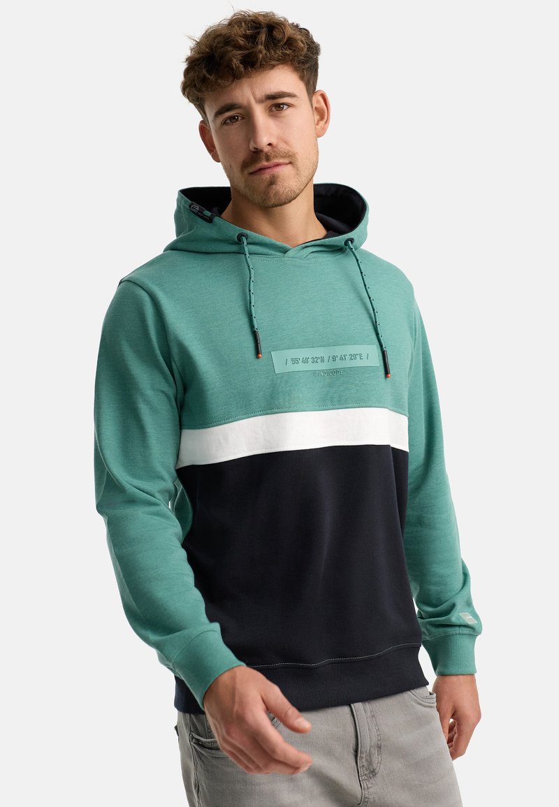Sweat-shirt à capuche en teal, marine et blanc ; présente un patch texturé sur la poitrine avec des coordonnées ; en mélange de coton ; poche kangourou ; poignets et ourlet côtelés.