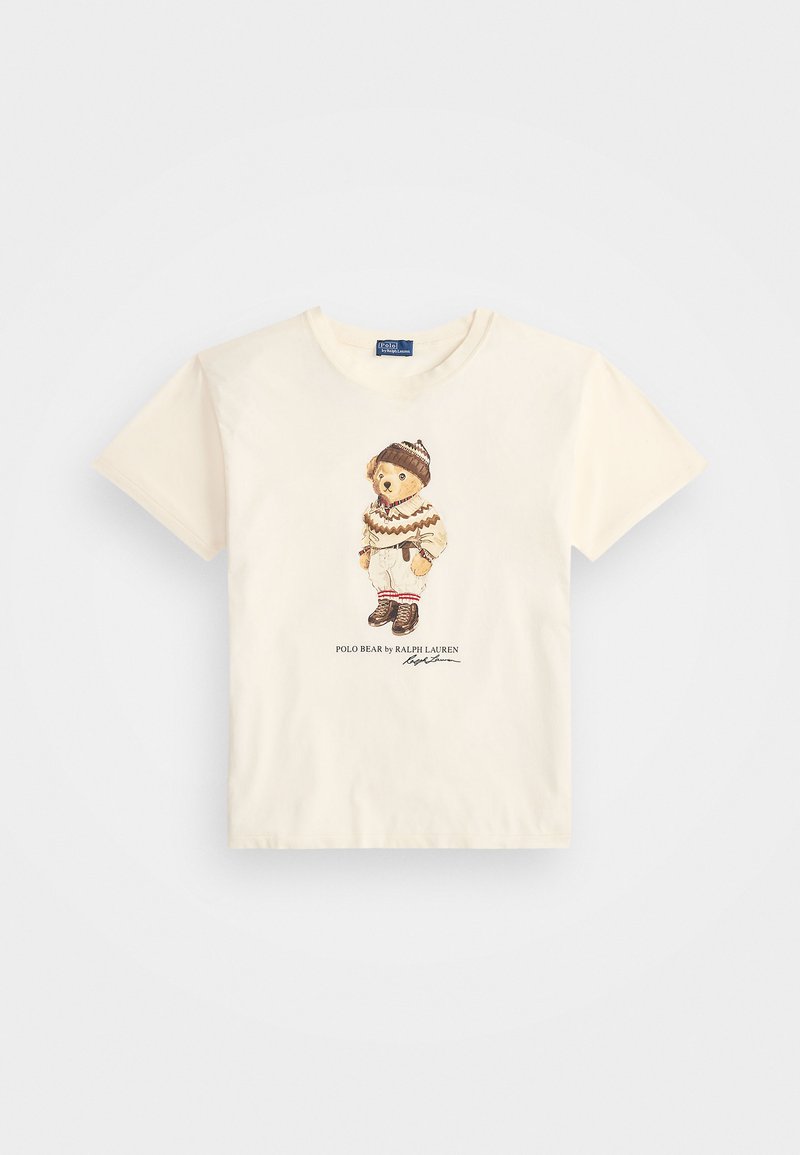 Kremowa koszulka z krótkim rękawem z grafiką niedźwiedzia w zimowym ubraniu, z brązowymi akcentami i napisem "POLO BEAR by RALPH LAUREN."
