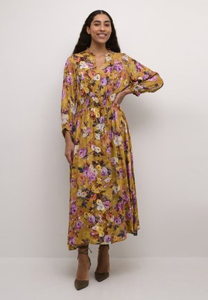 Blumen-Maxikleid in Gelb mit lila und rosa Blumen. Es hat einen V-Ausschnitt, lange Ärmel und einen elastischen Taillenbund für eine lockere Passform.