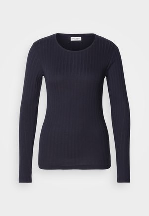 Topp marinblå med långa ärmar i ribbat material och rund hals. Tillverkad av mjukt tyg, har den en figurnära design och subtil textur genom hela plagget.