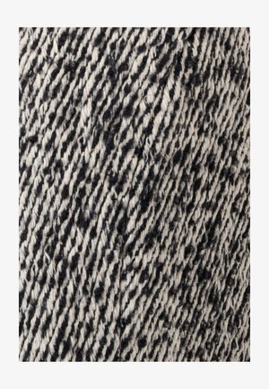 Tessuto con un motivo texturizzato in nero e crema. Il materiale appare tessuto con fibre visibili che creano un design a righe.