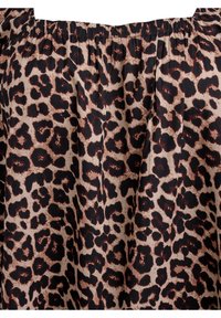 Leopard print fabric features a light beige background with dark brown spots, gathered at the top, displaying a textured surface.