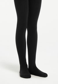 Collant neri realizzati in un materiale liscio ed elastico, che aderiscono perfettamente alle gambe. Nessun motivo o decorazione visibile. Lunghezza standard alla caviglia.