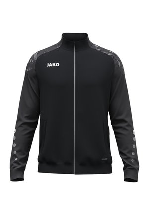 Černá sportovní bunda na zip s vysokým límcem, logo JAKO na hrudi, vzorované detaily na ramenou a malé kruhové vzory na rukávech.
