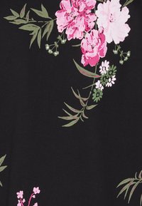 Black fabric featuring pink and white floral patterns, with green leaves and small white flowers, displaying varied textures and colors.