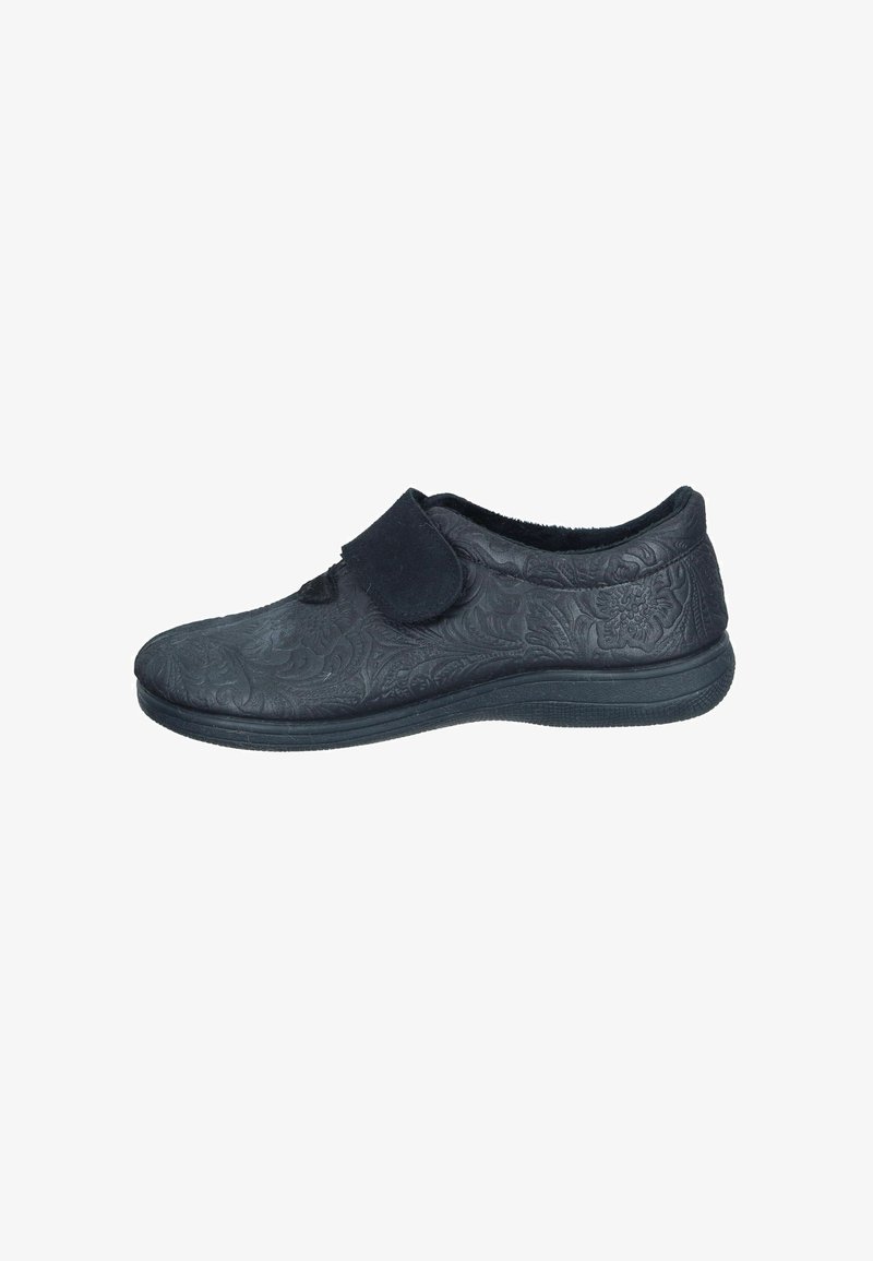 Black slip-on shoe with embossed floral pattern, soft upper material, a Velcro strap, and a textured rubber sole for traction.