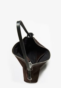 Brown suede handbag with a black leather strap and zipper closure, featuring a spacious interior and a structured, tapered design.