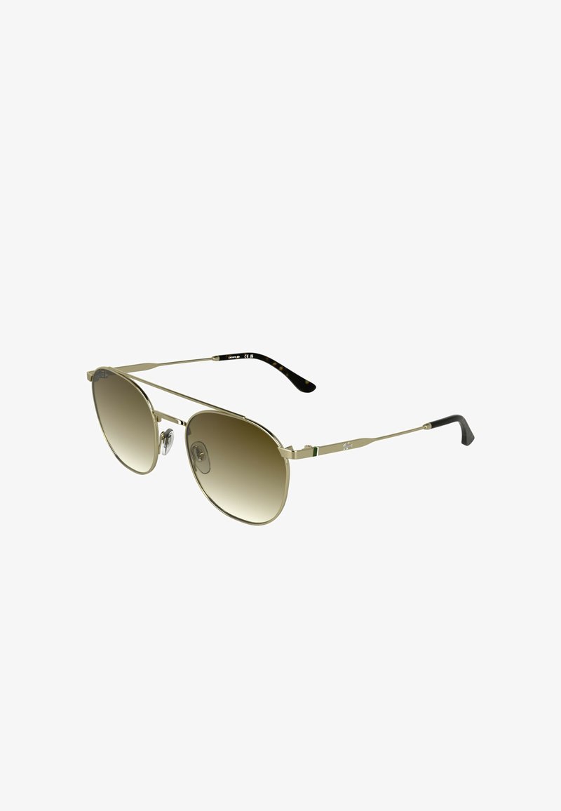 Lunettes de soleil aviateur en métal doré avec verres dégradés marron. Branches fines avec un accent noir et vert, équipées de plaquettes de nez réglables.