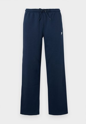 Mørkeblå joggebukser med elastisk midje, snøring, sidesømmer og en liten hvit logo øverst på venstre ben.