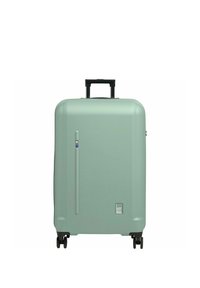 Valise rigide de couleur vert menthe mat, dotée d'une poignée rétractable noire, de quatre roues noires et d'un logo discret à la base.