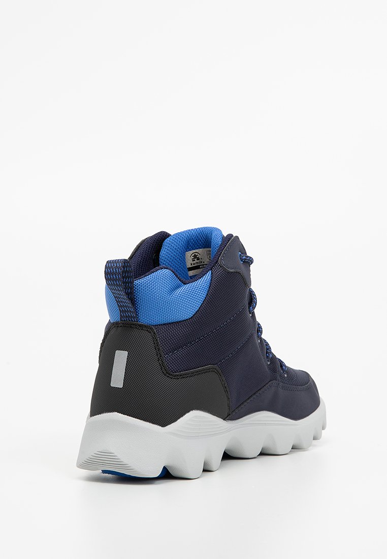 Półwysoki but turystyczny w kolorze granatowym z czarnymi akcentami, z teksturowaną górą z materiału, siateczkową podszewką i białą gumową podeszwą zapewniającą przyczepność.