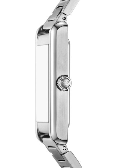 Metallic smartwatch with rectangular face and textured side button featuring a winged logo, attached to a linked metal strap.