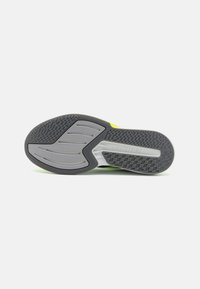 Grey and black shoe sole with a textured pattern, featuring a light grey central section and "LIGHTSTRIKE" branding embossed on the side.
