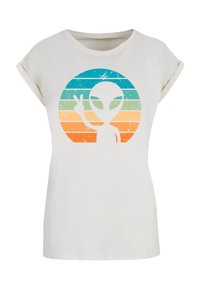 White cotton t-shirt with rolled sleeves featuring a graphic of an alien and peace sign, surrounded by colorful horizontal stripes.