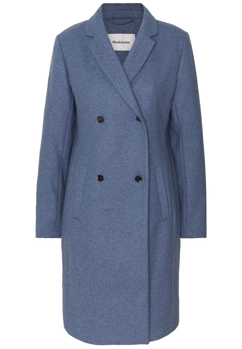 Doppelreiher aus blauer Wolle mit Reverskragen, zwei Fronttaschen und schwarzen Knöpfen, mit einer leicht strukturierten Oberfläche.