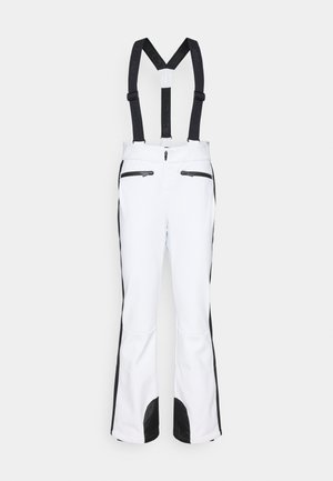 Pantalones de esquí blancos con acentos laterales negros y tirantes ajustables. Cuenta con dos bolsillos con cremallera en la parte delantera y dobladillos reforzados.