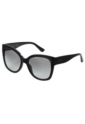 Fekete, oversized napszemüveg vastag kerettel, árnyékolt lencsékkel és oldalsó díszítésekkel. A templomon a "vogue" logó található.