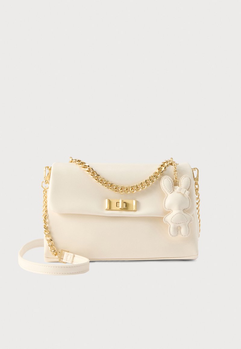 White faux leather shoulder bag with gold chain strap, featuring a magnetic clasp and a detachable bunny charm. Smooth texture, rectangular shape.
