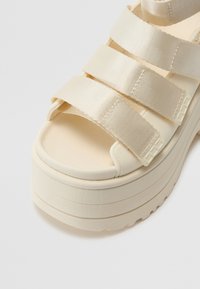 UGG GOLDENRISE - Sandály na platformě - jasmine