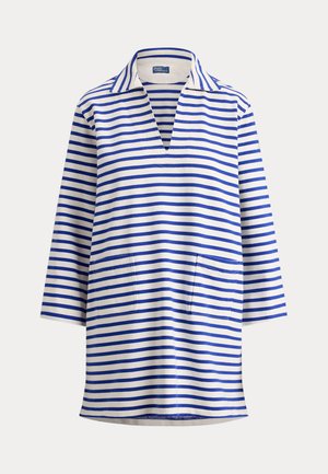 Biała tunika z długim rękawem z szerokimi niebieskimi poziomymi paskami, kołnierzem, dekoltem w serek i dwoma przednimi kieszeniami naszywanymi.