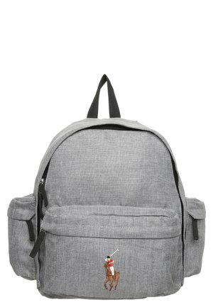 Grå rygsæk i stof med lynlåslommer foran og i siderne, sorte håndtag og en lille broderet polo-spiller i rød og hvid på den forreste lomme.