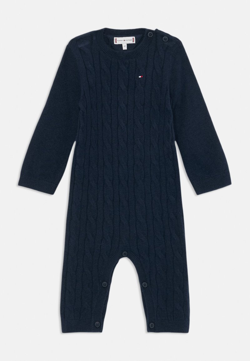 Μπλουζάκι με πλέξη κωδικού σε ναυτικό μπλε χρώμα, με μακριά μανίκια, κουμπιά στους ώμους και κουμπώματα στο κάτω μέρος για εύκολη ένδυση.