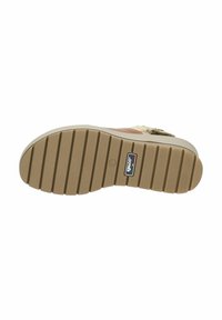 Suola in gomma con scanalature orizzontali, di colore beige, dotata di un piccolo tag con logo. Design minimalista e superficie texturizzata per una maggiore aderenza.