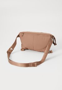 Brown nylon crossbody bag with a zippered top, flat shape, adjustable strap, and two front pockets. Smooth texture, minimal design.