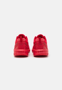 Red athletic sneakers with a breathable mesh upper, padded collar, and dotted rubber sole for cushioning. Features Kappa logo on heel.