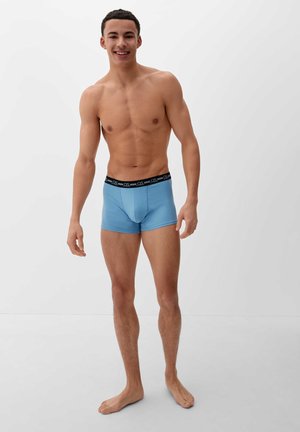 Light blue boxer shorts with a black elastic waistband featuring the brand logo. Smooth texture with a form-fitting design.