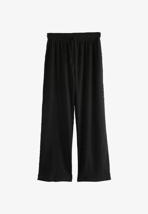Black wide-leg pants with a textured fabric, featuring an elastic waistband and adjustable drawstring. Loose fit for comfort.