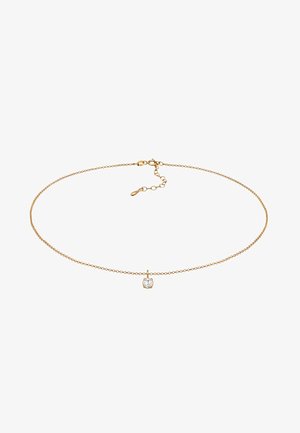 Kuldne kaelakee, millel on õrn disain ja ümmargune kristallripats. Kaelakee on tekstuuriga viimistlusega ning sellel on reguleeritav kinnitis.