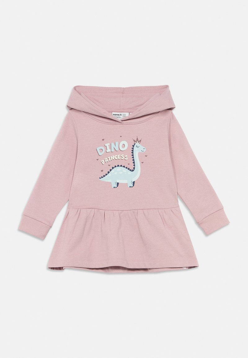 Rožinė ilgomis rankovėmis kūdikio suknelė su pūsta sijonėliu ir dinozauru, kuris dėvi karūną, su tekstu "Dino Princesė."