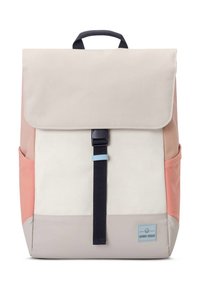 Backpack with a flap top in beige, white, and coral colors. Features a navy strap and buckle closure. Smooth fabric texture, minimal branding.