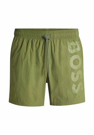 Olive green swim shorts made of lightweight fabric, featuring an elastic waistband with drawstring and a large "BOSS" logo in light green on the side.
