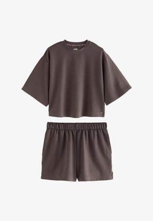 Two-piece brown ribbed fabric set with a short-sleeve cropped top and elastic waist shorts.